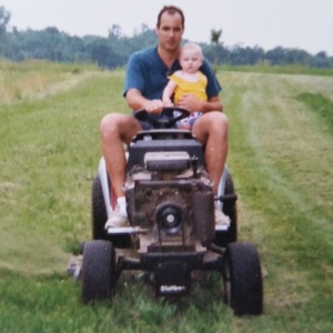 Daddy and Grandson riding the little tractor